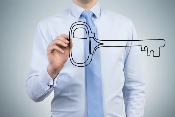 Man with only chest seen drawing a key in front of him with a pen. — Stockfoto