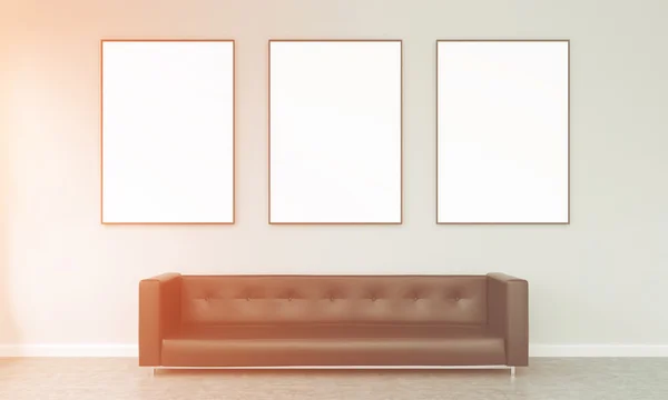 Three frames over a sofa — Zdjęcie stockowe