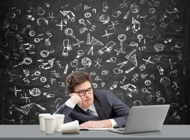Young man sleeping at working place