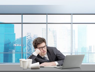 Young man sleeping at working place