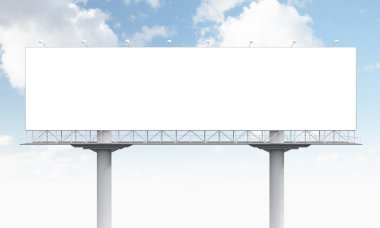A huge blank billboard on two supports, blue sky at the background.