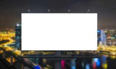 huge blank billboard in the city centre at night, blurred background.