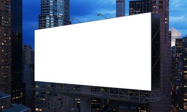 huge blank billboard in the city centre at night.
