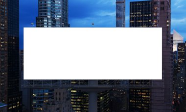 huge blank billboard in the city centre at night.