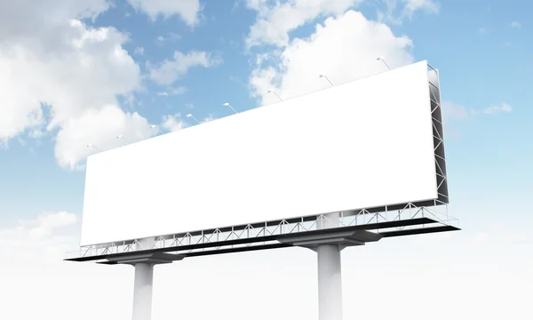 A huge blank billboard on two supports, blue sky at the background. — Stock Photo, Image