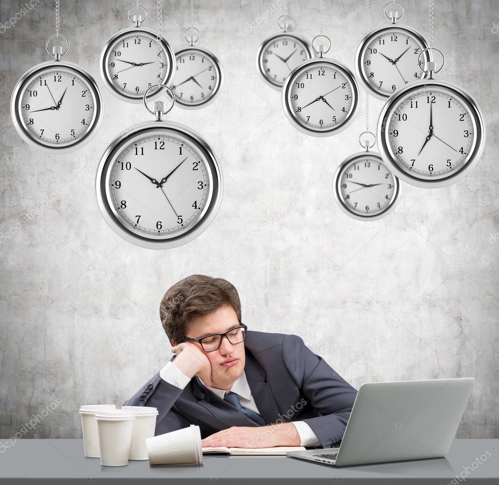 Young man sleeping at working place