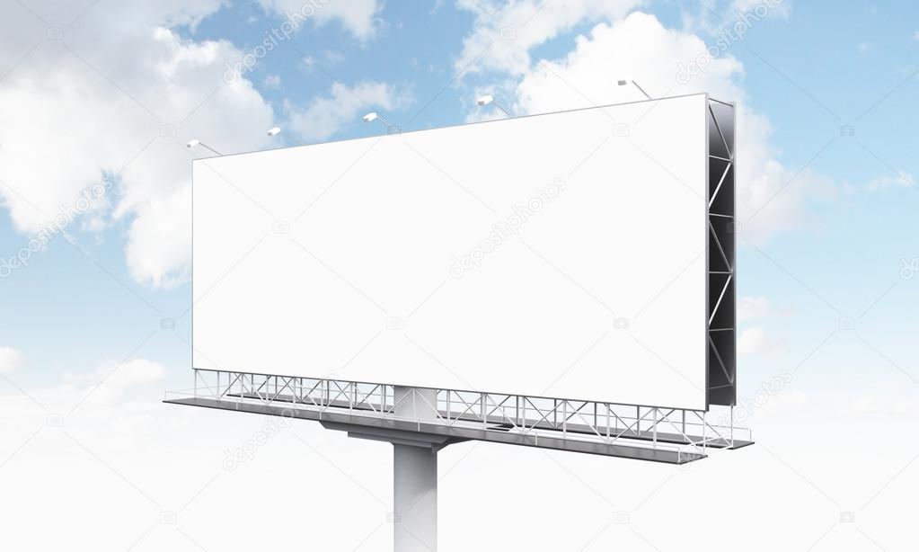 A huge blank billboard on one support, blue sky at the background.