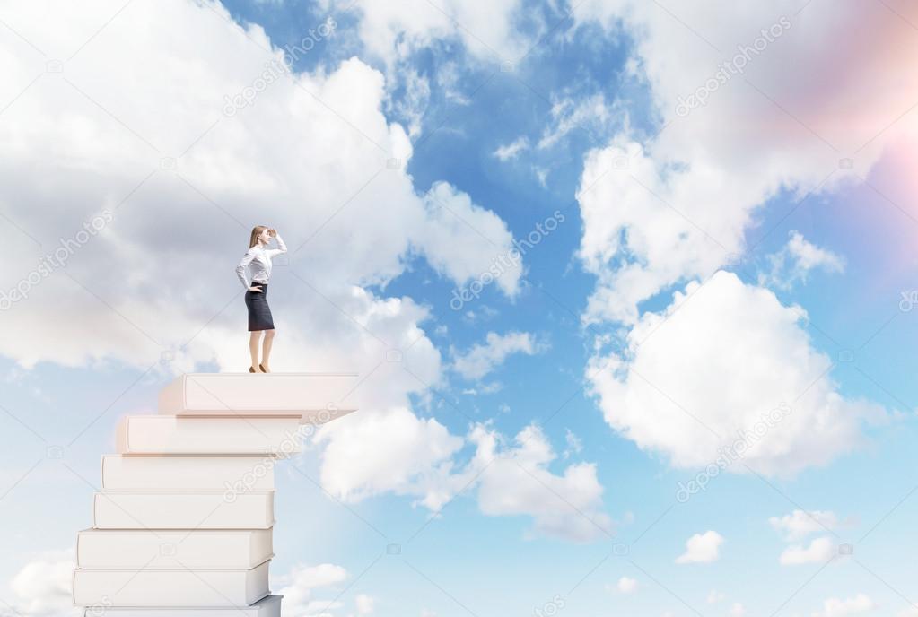 Woman on a pile of books