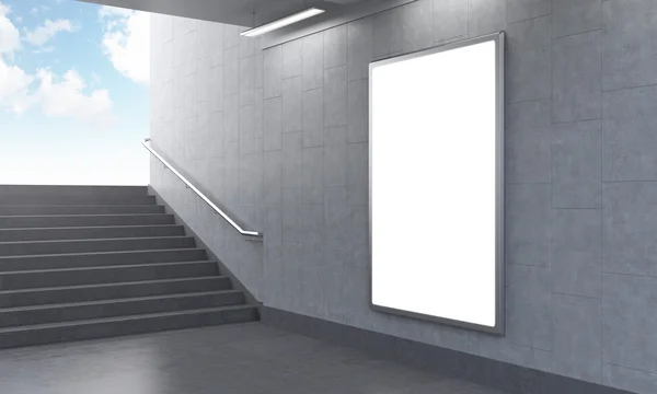 One vertical billboard in the underground, stairs up to the left, light seen. — Stockfoto