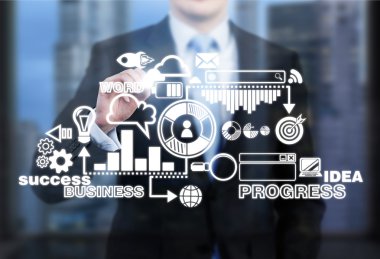 A businessman standing in front of a business scheme touching it with fingers. Front view, no head seen.