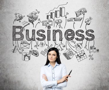 A young beautiful woman standing with hands crossed and holding a pen, the word 'business' and numerous business symbols over her head.