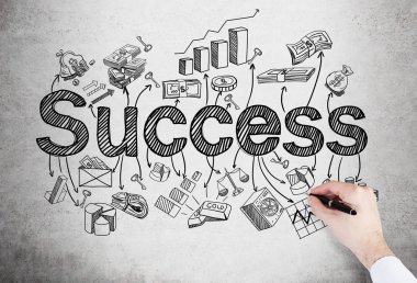 A hand drawing many different business icons and the word 'success' on the concrete wall. Concept of successful business development.
