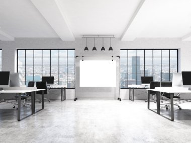 Two rows of computer tables in a light modern open space office, a big blank screen on the wall between the windows with Paris view, four lamps over it.