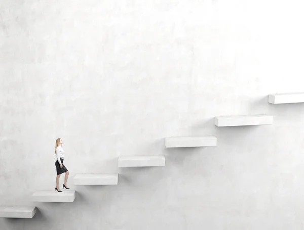 A young woman going upstairs steadily. — Stock Photo, Image