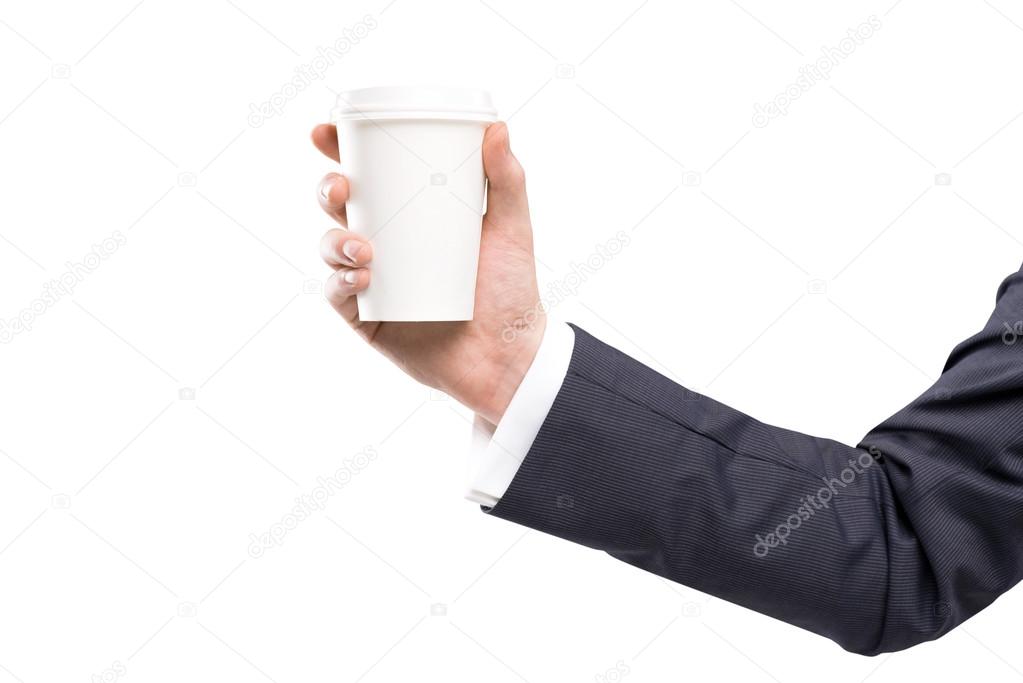 A hand in a black suit holding a paper cup.