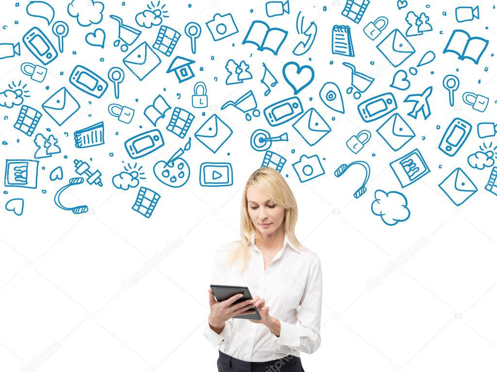 beautiful young woman holding her tablet, blue symbols of social networks over her. White background. Concept of online communication.