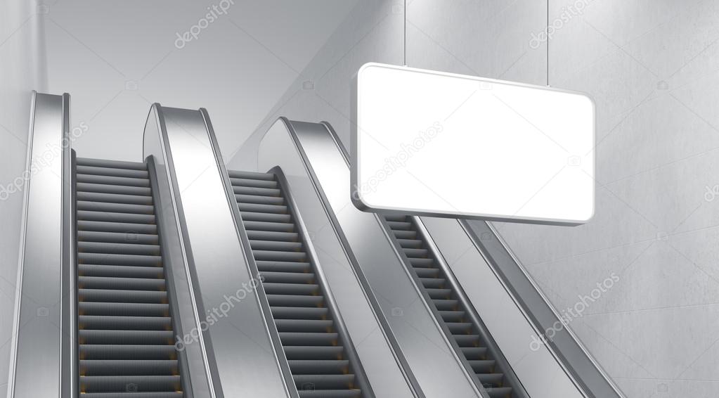 An escalator in the underground. A blank horizontal poster hanging in front of it.c Side view. Concept of underground advertising.
