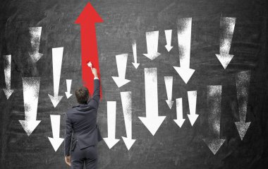 A man painting arrows