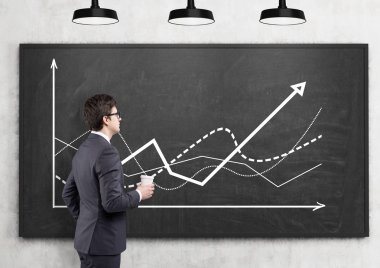 A businessman studying graphs