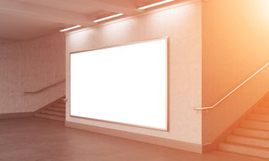 A big blank horizontal billboard in the underground, stairs up on both sides.