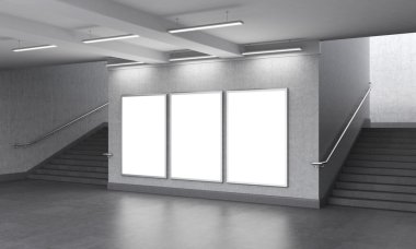 Three blank vertical billboard in the underground, stairs up on both sides.