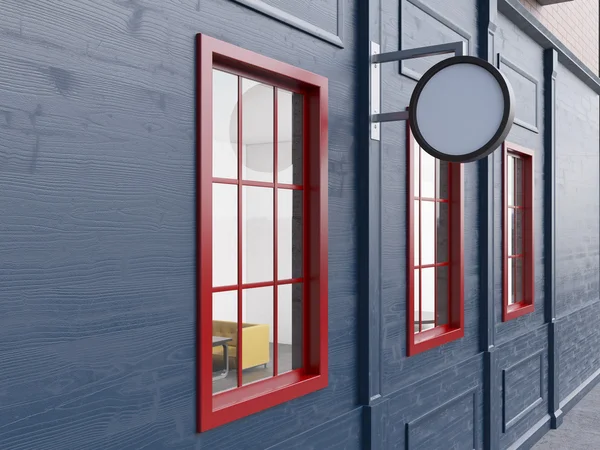 A pub with three red windows and a round blank board for a name between them. — Stockfoto