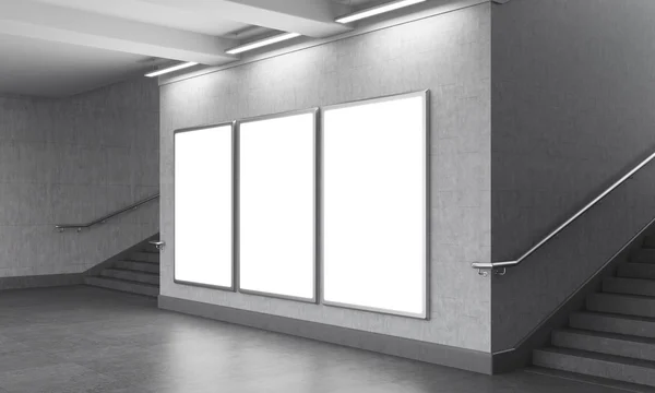 Three blank vertical billboard in the underground, stairs up on both sides. — Stockfoto