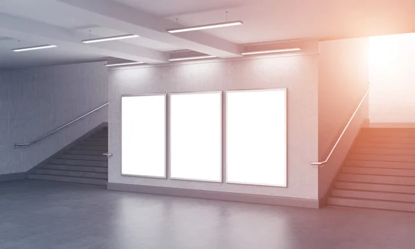 Three blank vertical billboard in the underground, stairs up on both sides. — Stock Photo, Image
