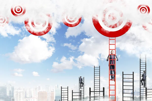 A young businessman climbing a red ladder to the sky, two men climbing other ladders. — Stock fotografie