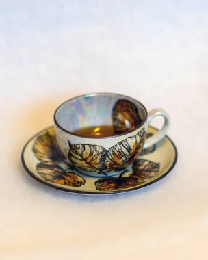 Süslü çay fincanı ve beyaz arka planda fincan tabağı ile resim