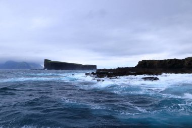 a dramatic view of Drangarnir gate in front of Tindholmur in Vagar island, Faroe Islands, Denmark, north atlantic ocean