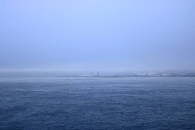 Misty Views on the way out of the city Torshavn, Faroe Islands in Denmark by ferry