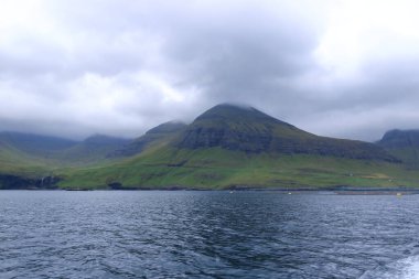 view of the green hills of Vagar island near Sorvagur town, Faroe islands, Denmark