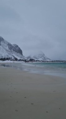 Norveç 'in Lofoten adalarında Ramberg plajı ya da Rambergstranda kışı. Kuzey kumlu sahili ve Norveç denizinin berrak suları olan kış manzarası.