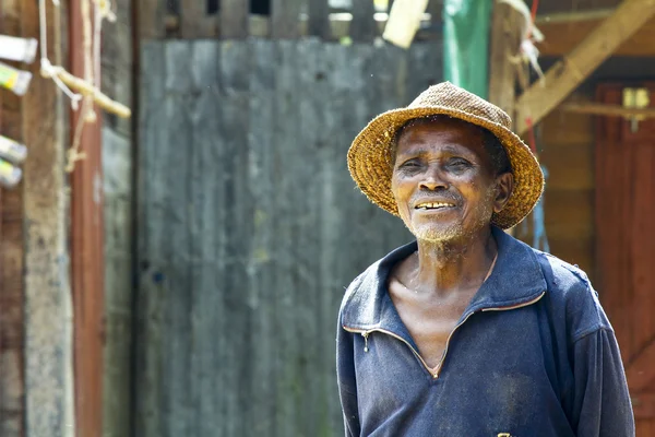 Old african american homeless man outdoors with sad eyes.