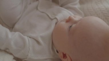 Üç aylık güzel bir kızın evde yatarken çekilen yüksek açılı görüntüsü.