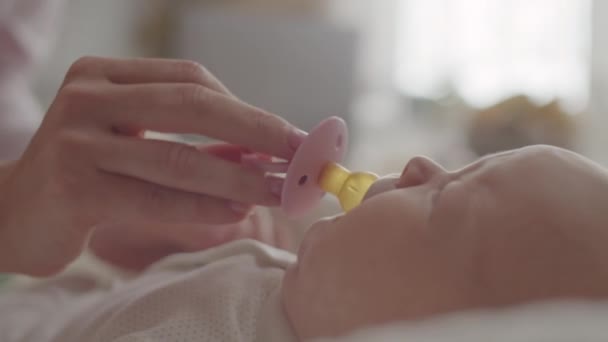 Close Shot Hands Mother Giving Pacifier Crying Month Old Baby — Stock Video