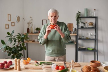 Adam mutfakta yemek pişiriyor.