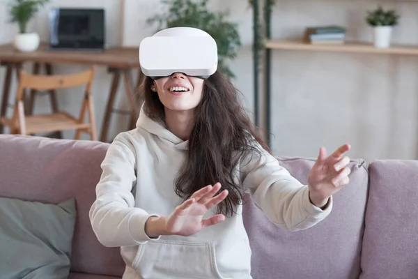 Virtual reality game sitting on sofa at home