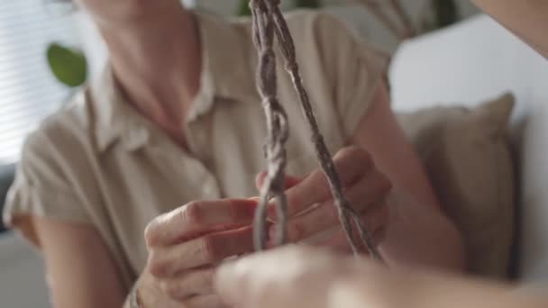 Dutch Angle Shot Young Caucasian Woman Tying Rope Knots While — Stock Video