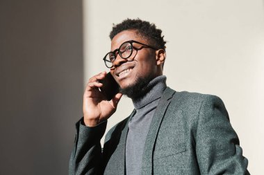 Afrikalı adam telefonda konuşuyor.