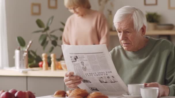 Portrait Elderly Caucasian Man Holding Newspaper Looking Camera While Sitting — Stock Video