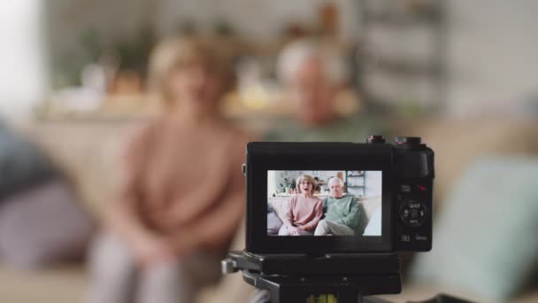 Rack Focus Shot Cheerful Senior Couple Sitting Sofa Home Embracing Video Clip