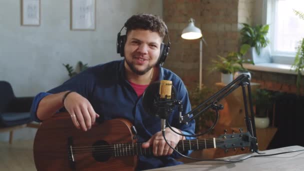 Young Cheerful Hispanic Man Headphones Sitting Guitar Recording Studio Smiling — Stock Video