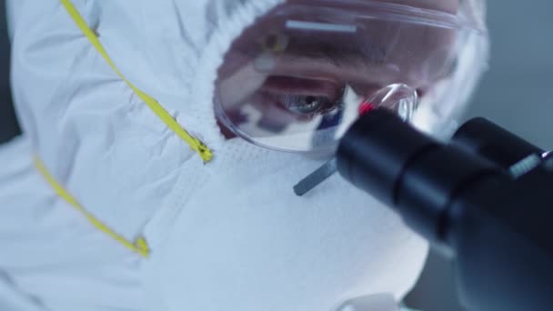 Мужчина Ученый Защитной Маске Очках Костюме Двигает Лицо Ближе Микроскопу — стоковое видео