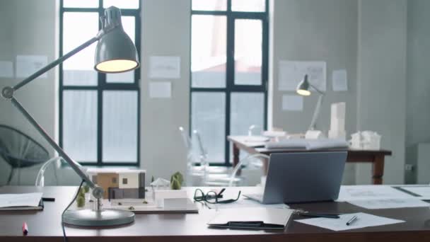 Дуговой Снимок Стола Лампой Ноутбуком Бумагами Моделью Здания Архитектурном Офисе — стоковое видео