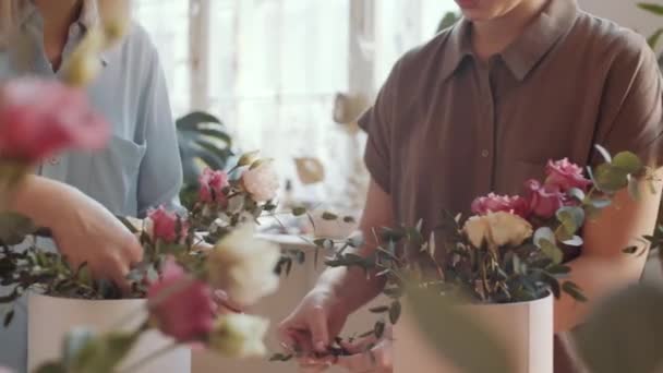 Midsection Skott Två Unga Kvinnor Att Diskutera Och Ordna Blombuketter — Stockvideo