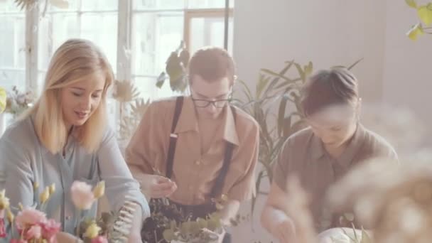 Glada Kvinnliga Florist Leende Och Förklara Något För Kollegor Samtidigt — Stockvideo