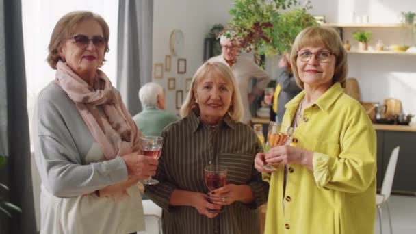 Portrait Three Happy Senior Women Standing Home Holding Wine Glasses — Stock Video