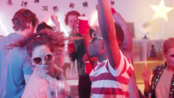 年轻迷人的白人女人 拿着迪斯科舞会 带着时髦太阳镜在家里和朋友们跳舞 — 图库视频影像